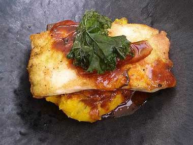 A photograph of paiche with mandarin sauce.
